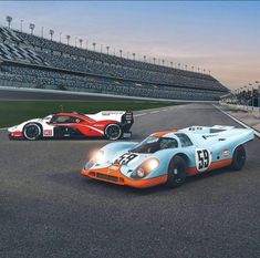 two race cars driving on a track in front of an empty stadium