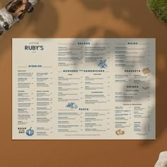 the menu for ruby's restaurant is displayed on a table