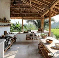 an outdoor kitchen is shown in the middle of a rice field with lots of greenery