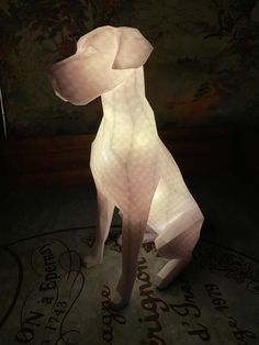 a white dog statue sitting on top of a floor next to a wall covered in writing