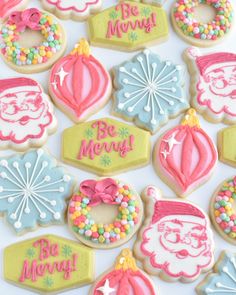 decorated christmas cookies are displayed on a table