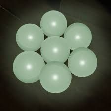 a bunch of white balls sitting on top of a table