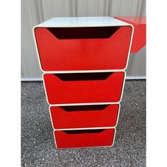 three red drawers are stacked on top of each other