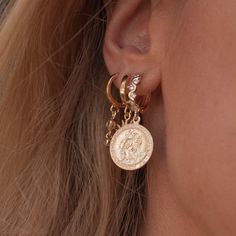 "Traveler's coin earrings, made with the holy Patron Saint Christopher coin earrings. Statement gold hoop earrings featuring a large round saint Christopher protection disc pendant suspended from a studded gold hoop earrings. Inspired by the Roman coin jewelry, we've created statement Traveler's Coin earrings. The huggie hoop is detailed with gorgeous zirconia diamonds and gold balls, creating a dramatic yet subtle touch the every hoop. The crystal detailed hoops are custom made for our shop, so Coin Huggie Earrings, Gold Coin Pendant Earrings, Gold Plated Coin Pendant Charm Necklace, Elegant Gold Coin Earrings, Gold-tone Coin Pendant Charm Necklace As Gift, Brass Medallion Earrings With Coin Pendant, Roman Coin Jewelry, Saint Christopher, Coin Earrings