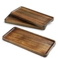 two wooden trays sitting on top of each other