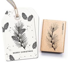 a rubber stamp with a pine tree on it next to a christmas ornament