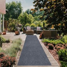 an outdoor area with couches, chairs and plants