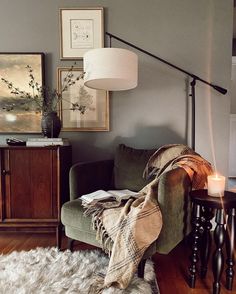 a living room filled with furniture and a lamp