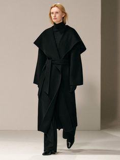 This luxurious 100% wool coat combines timeless elegance with practical warmth, featuring a versatile drape design and generous shawl collar that can be styled multiple ways with the detachable belt. The relaxed silhouette offers a comfortable, blanket-like embrace while maintaining a sophisticated profile perfect for any season. Handcrafted with meticulous attention to detail, this coat includes functional elements like side welt pockets, a back center vent, and full twill lining, making it bot Oversized Black Wool Coat, Row Aesthetic, Oversized Overcoat, Christmas Board, Kimono Coat, Wool Tie, Black Wool Coat, Crochet Clothing, Designer Drapes