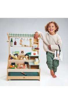 Let imaginations soar with this beautifully crafted wooden market stall designed with an adjustable canopy, interchangeable platforms and a tote for shopping. Style Name:Tender Leaf Toys General Stores Wooden Play Set. Style Number: 6265700. Toys Market, Play Market, Grocery Supermarket, Market Stands, Wooden Playset, Stall Designs, Market Stall, Play Shop, Fabric Tote Bags