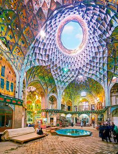 the inside of an ornate building with lots of windows and colorful decorations on the ceiling