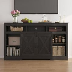 an entertainment center with a flat screen tv mounted above it