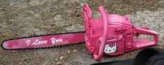 a pink hello kitty chainsaw laying on the ground