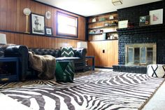 a living room with zebra print rug and fireplace