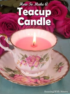 a teacup with a lit candle in it next to pink roses