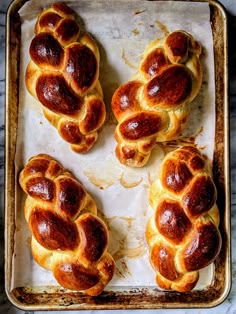 four hotdogs on a baking sheet ready to be baked