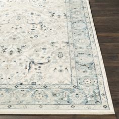 a large rug with an ornate design on the top and bottom in light blue tones