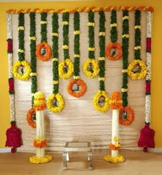 an arrangement of flowers and garlands on the wall