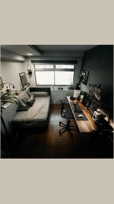 a room with a bed, desk and computer on the table in it's corner