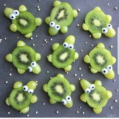 kiwis with googly eyes are arranged in the shape of fish and turtle