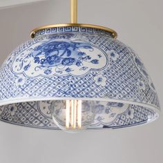 a blue and white lamp hanging from a ceiling