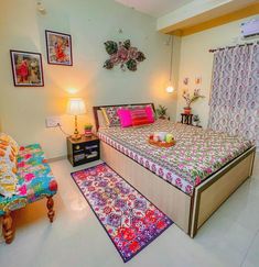 a bed room with a neatly made bed and colorful rugs on the floor next to it