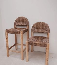 two wooden chairs sitting next to each other