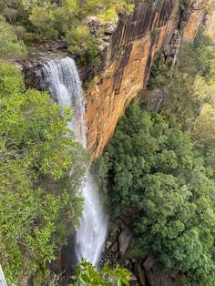 a waterfall in the middle of some trees