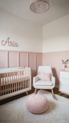 a baby's room with pink walls and white furniture