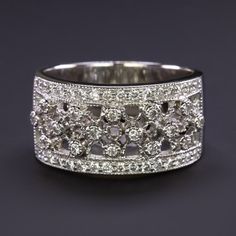 an antique style diamond ring with two rows of diamonds in the middle and one row of round