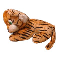 a stuffed tiger laying down on its side