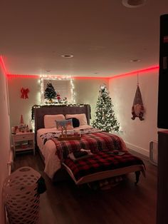 a bed room with a neatly made bed and christmas decorations