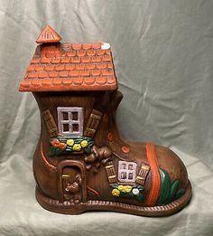 a wooden shoe shaped like a house