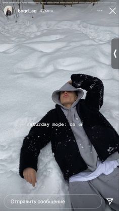 a person laying in the snow wearing a hat