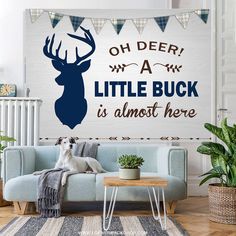 a dog sitting on top of a blue couch in front of a wall with a deer sign