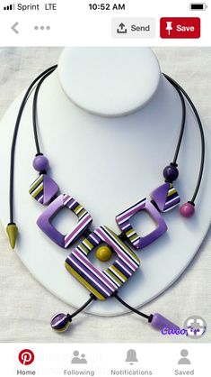 a necklace with purple and yellow letters on it