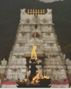 a fire is lit in front of a temple