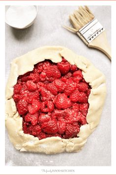 a raspberry pie sitting on top of a table next to a brush