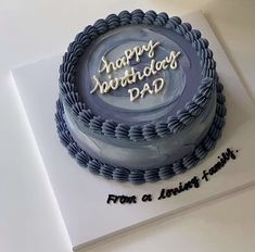 a birthday cake with the words happy birthday dad written on it is sitting on top of a card