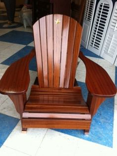 a wooden chair sitting on top of a checkered floor