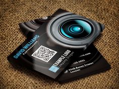 a close up of a business card with a camera on the front and back of it