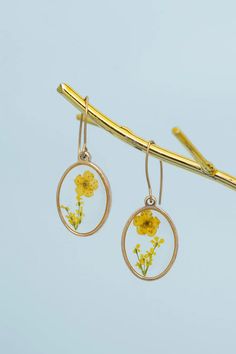 Ethical jewelry: Dried yellow flowers encased in resin within a 14K gold plated setting. Hypoallergenic stainless steel hooks. Size: 1.3 inches. Purchasing supports women in Asia escaping human trafficking to establish independence and careers. Women Supporting Women, Plate Sets, Yellow Flowers, Daily Wear