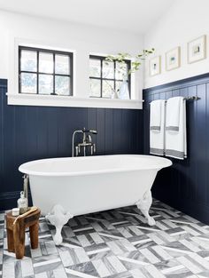 a white bath tub sitting next to a window