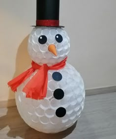 a snowman made out of golf balls on the floor