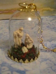 a snow globe with two figurines under it