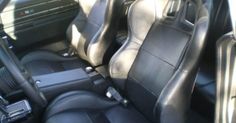 the interior of a car with black leather seats