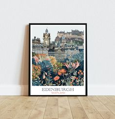 the edinburgh skyline with flowers in front of it on a wooden floor next to a white wall