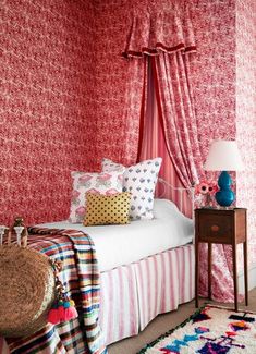 a bedroom decorated in pink and red tones