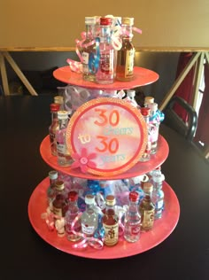 a three tiered cake decorated with bottles and candy on it's sides, labeled 30th birthday