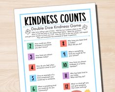 a printable kindness counts game on a wooden table